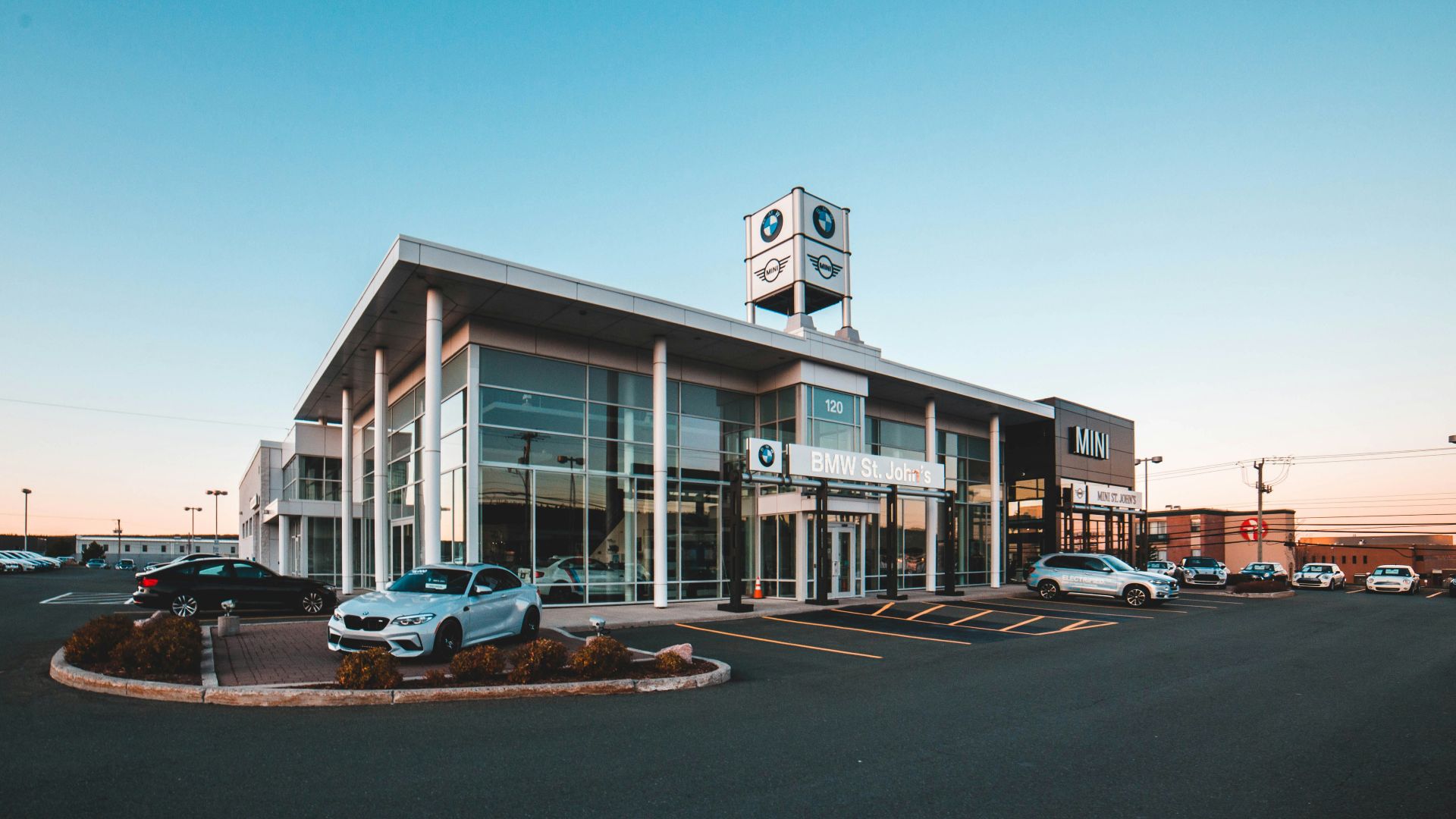different vehicles near glass walled building