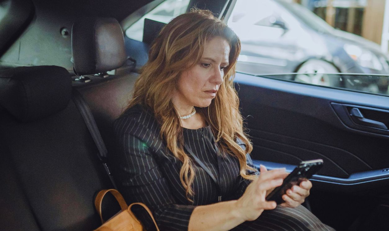 Woman with Cellphone in Car