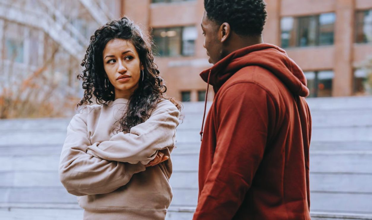 Disappointed multiethnic couple having argument on street