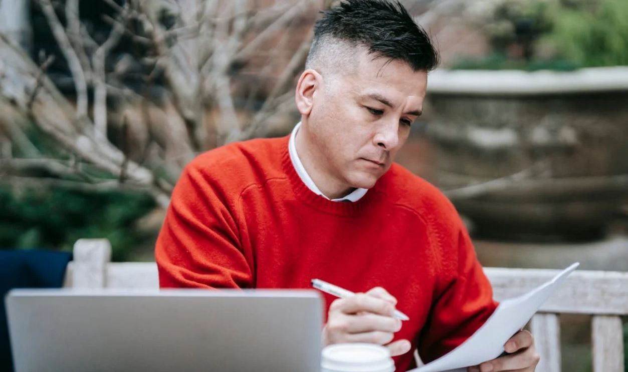Photo Of Man Reviewing Documents