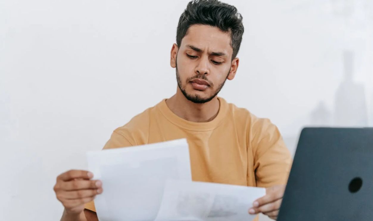 Man looking through documents at workplace