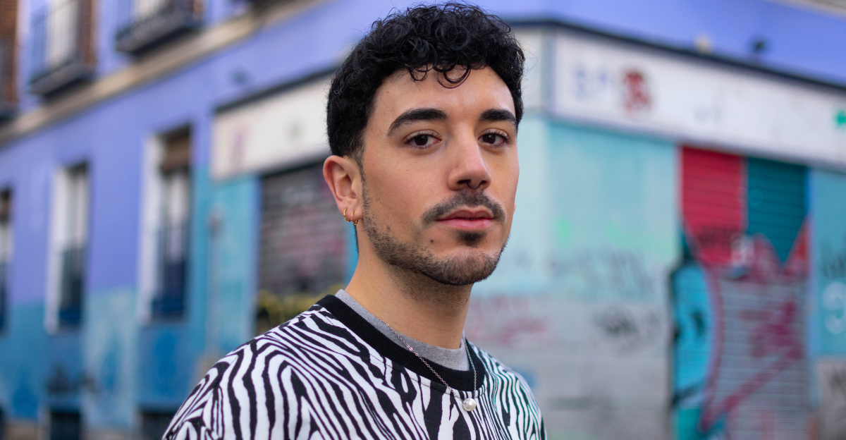 Young hispanic man with serious expression standing at the city