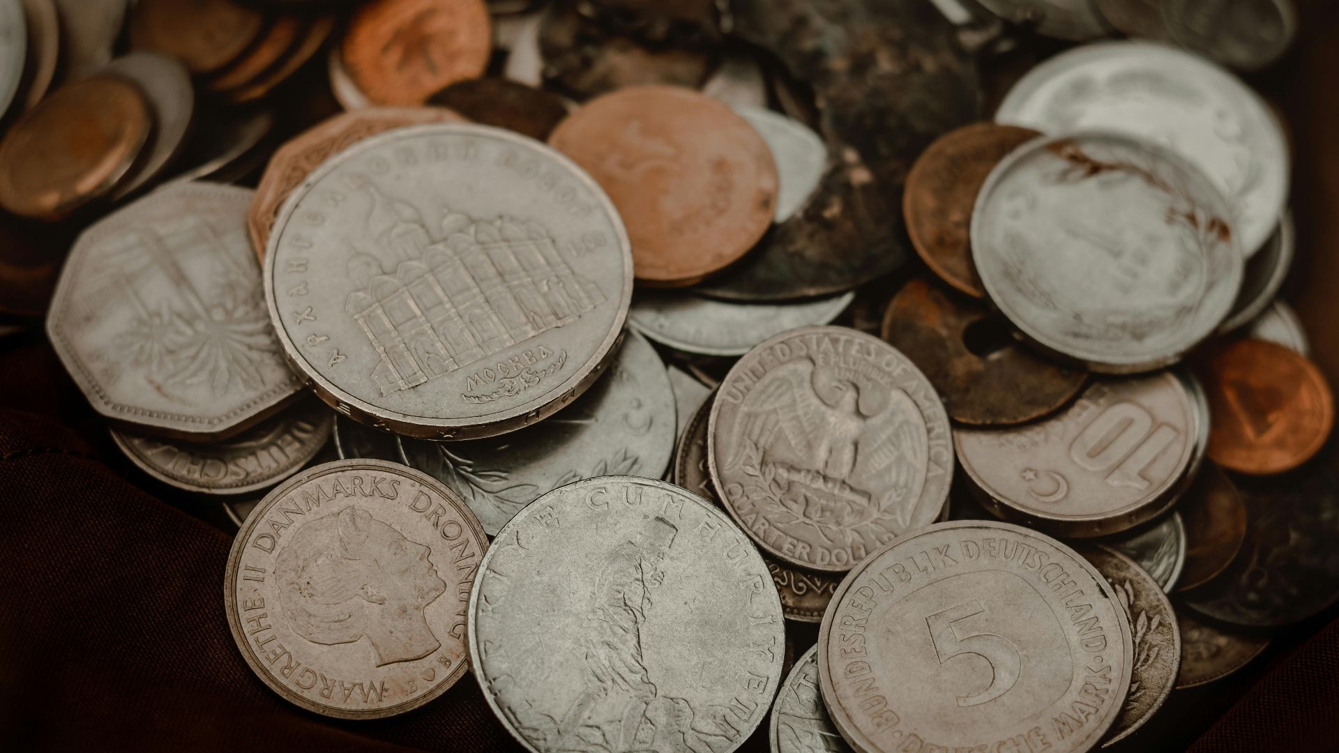Collection of various vintage coins showcasing global currency diversity.