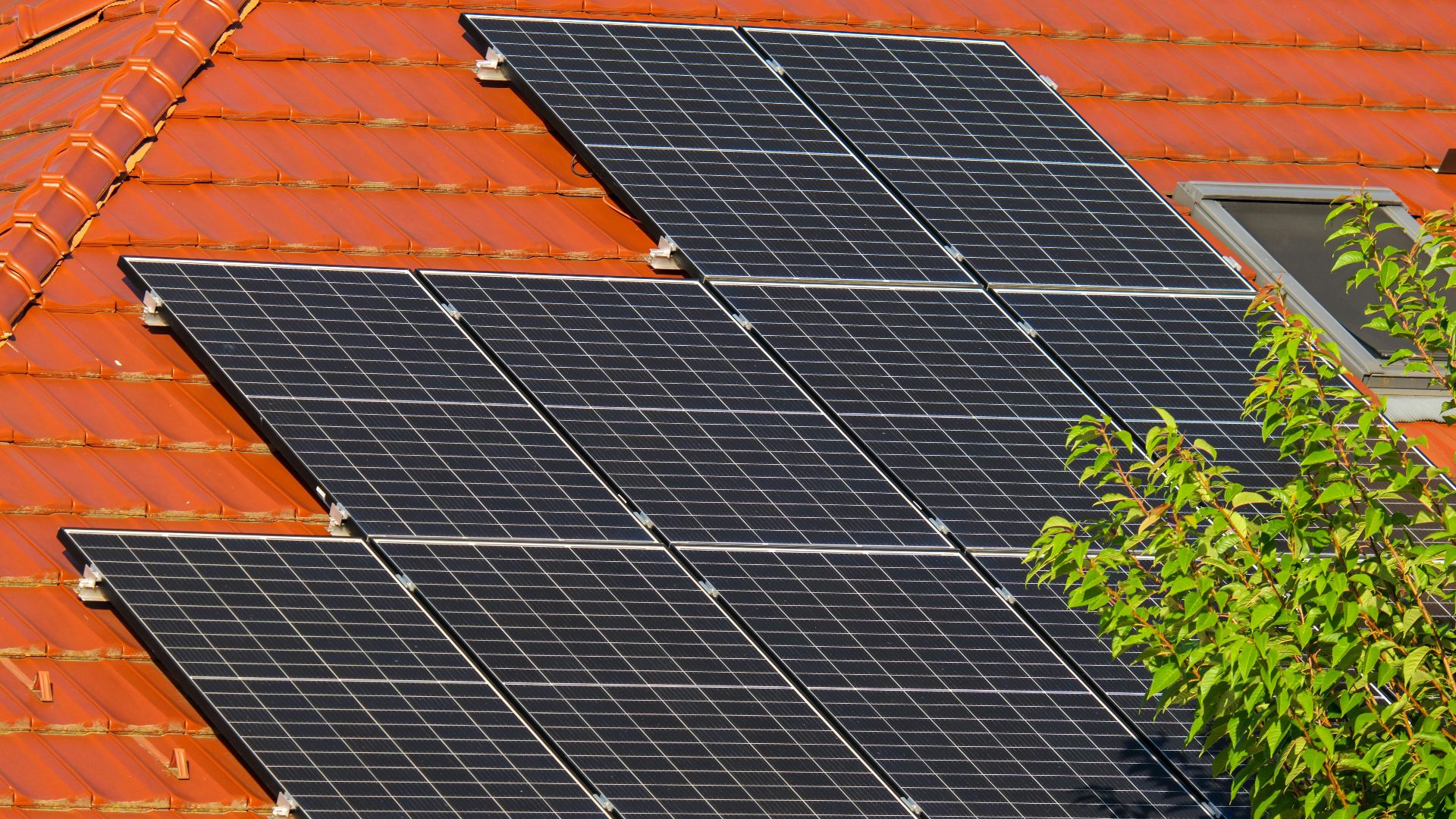Close-up of solar panels on a red tiled roof in Croatia, highlighting renewable energy.