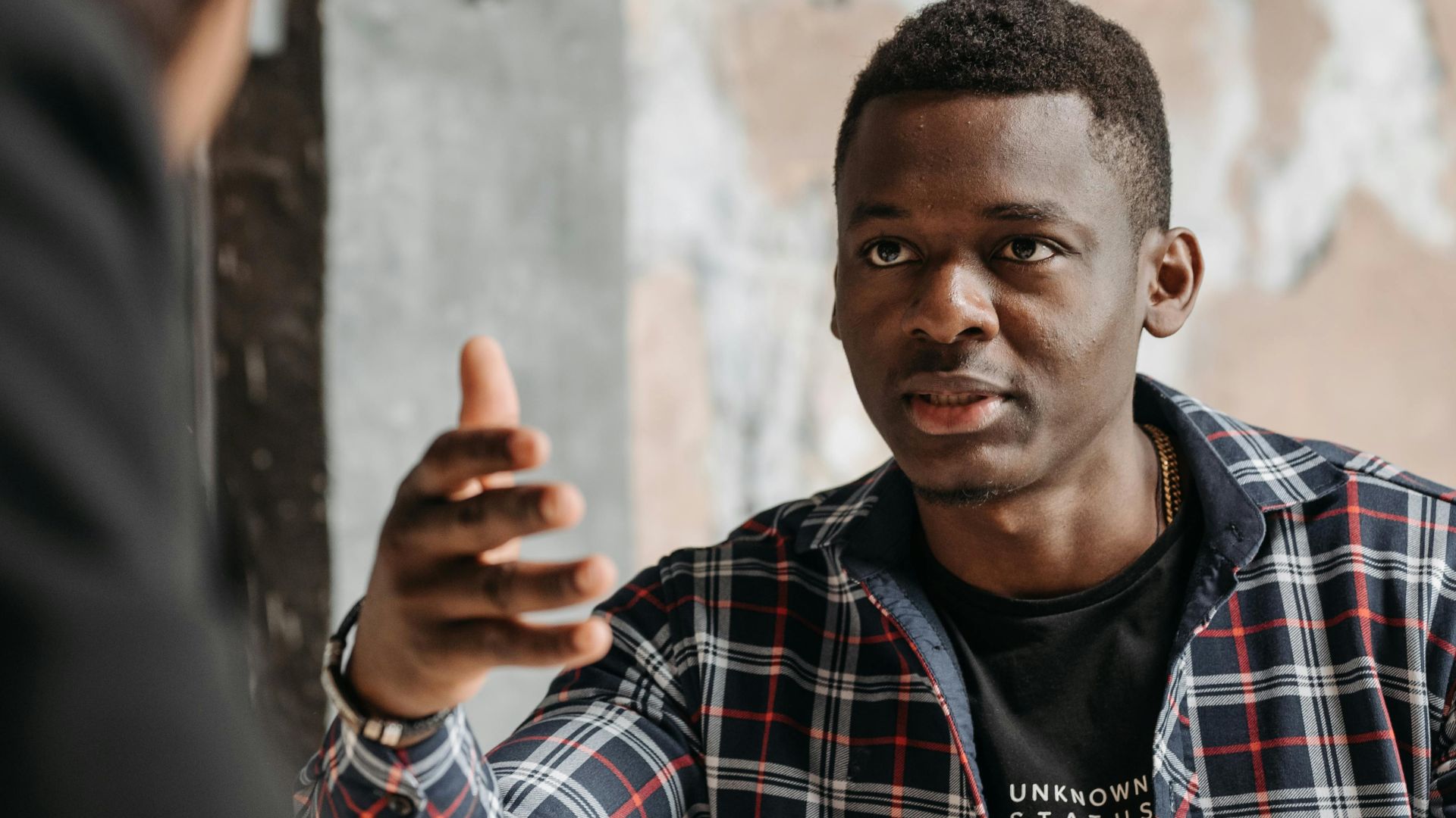 Business interaction between two adults discussing documents in a modern office.