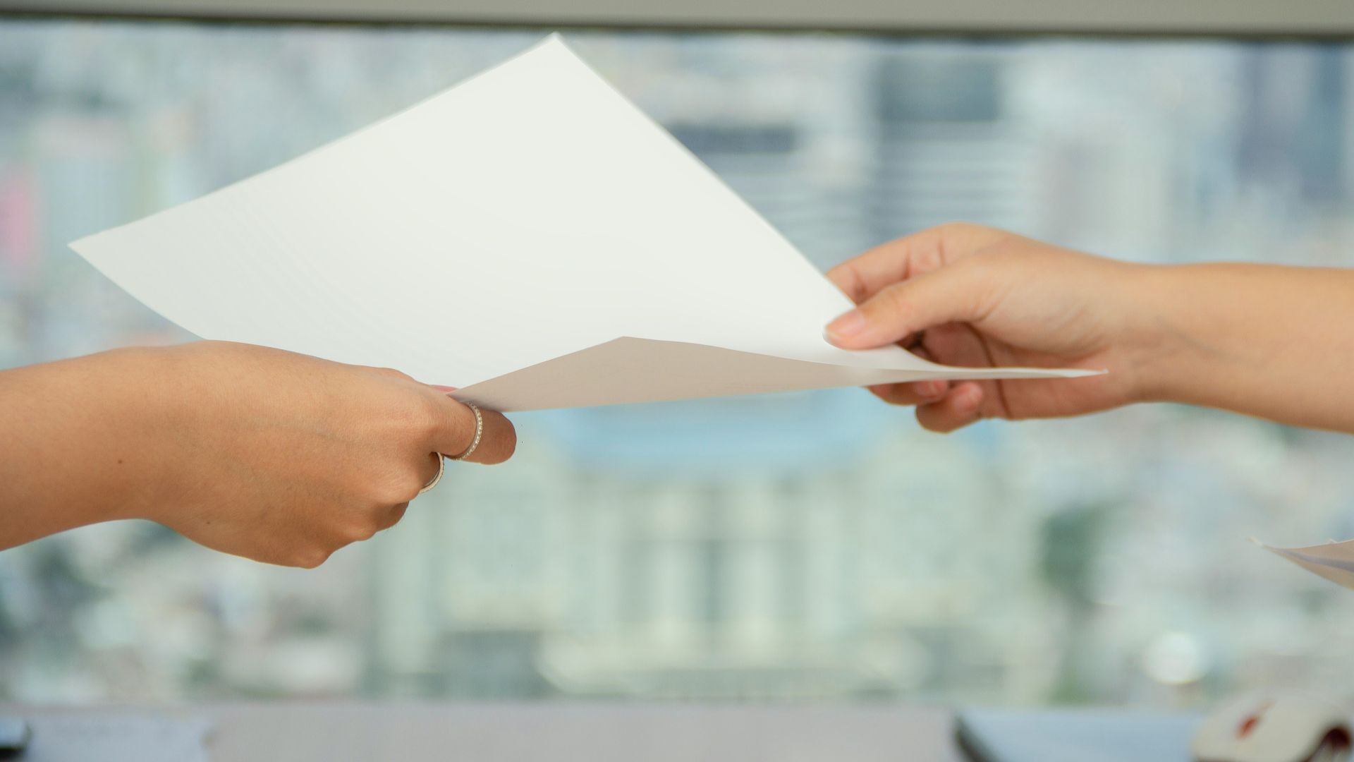 person handing over paper
