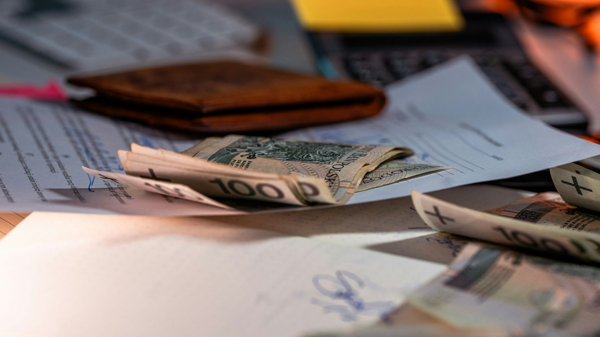 Money and documents on a desk.