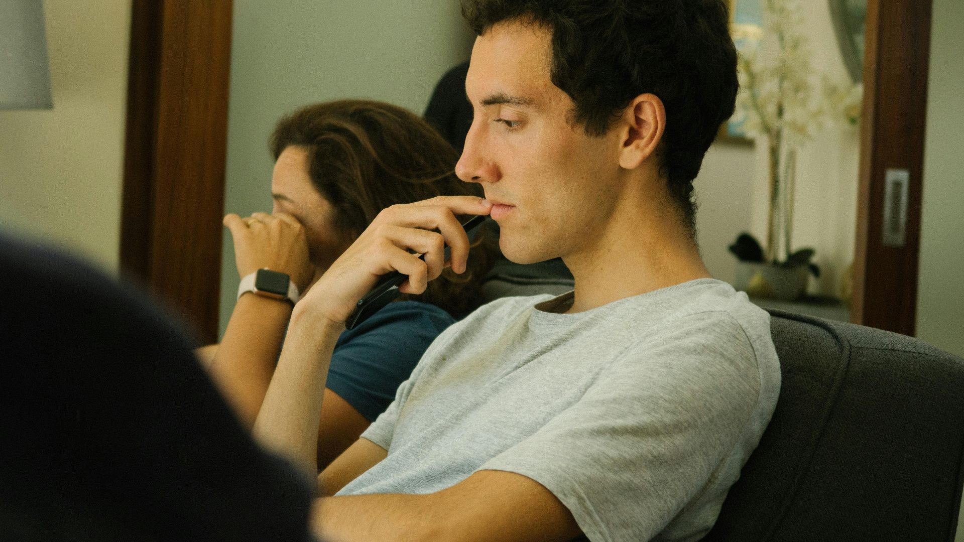 Two people sitting indoors, deep in thought and contemplation.