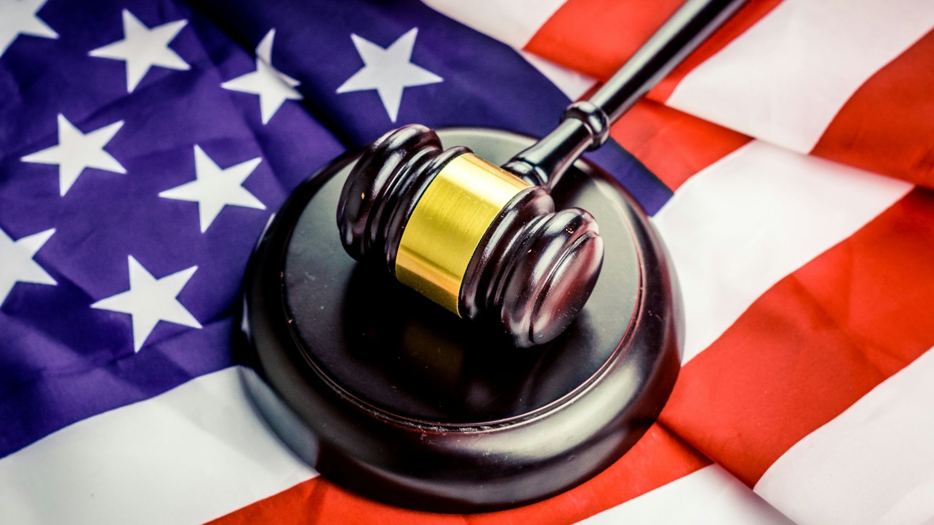 a judge's gavel on top of a flag