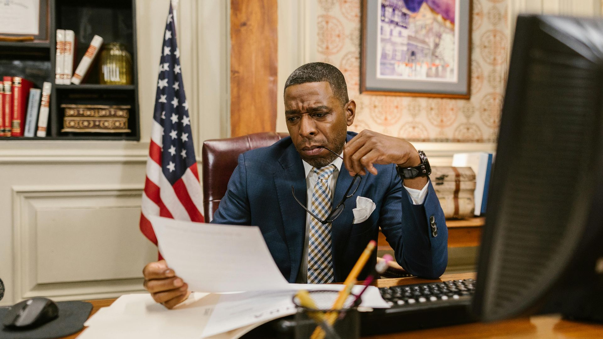 A focused lawyer reading documents in an office, symbolizing professionalism and legal expertise.
