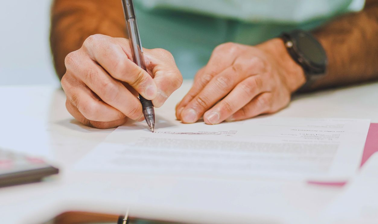 A Person Writing on White Paper