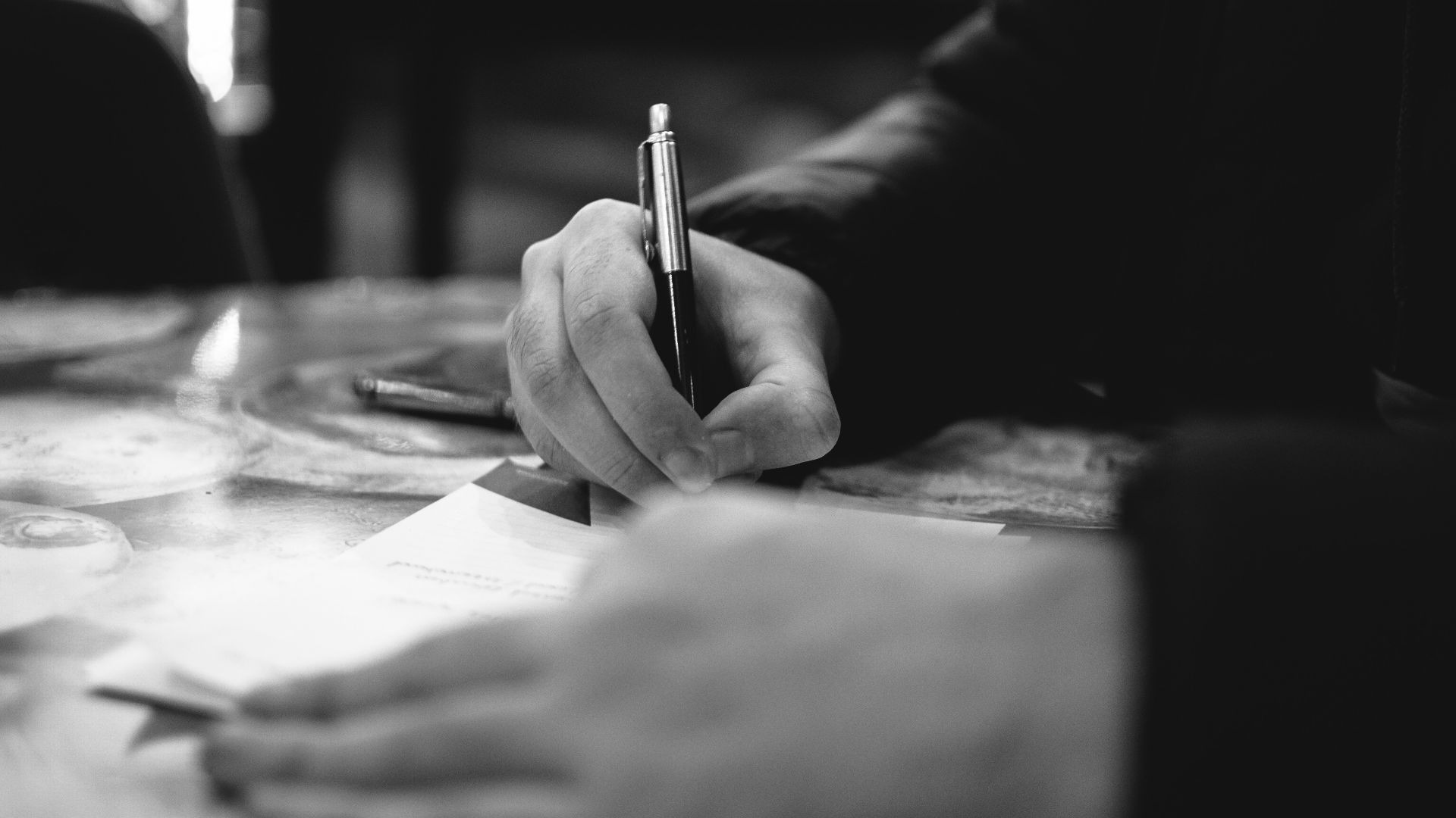 person writing on white paper