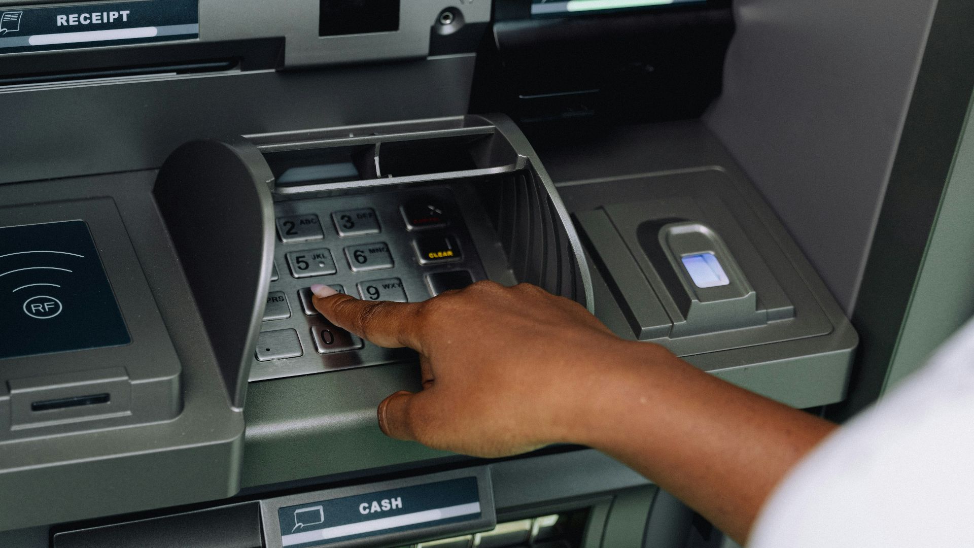 a person using an atm machine to pay money