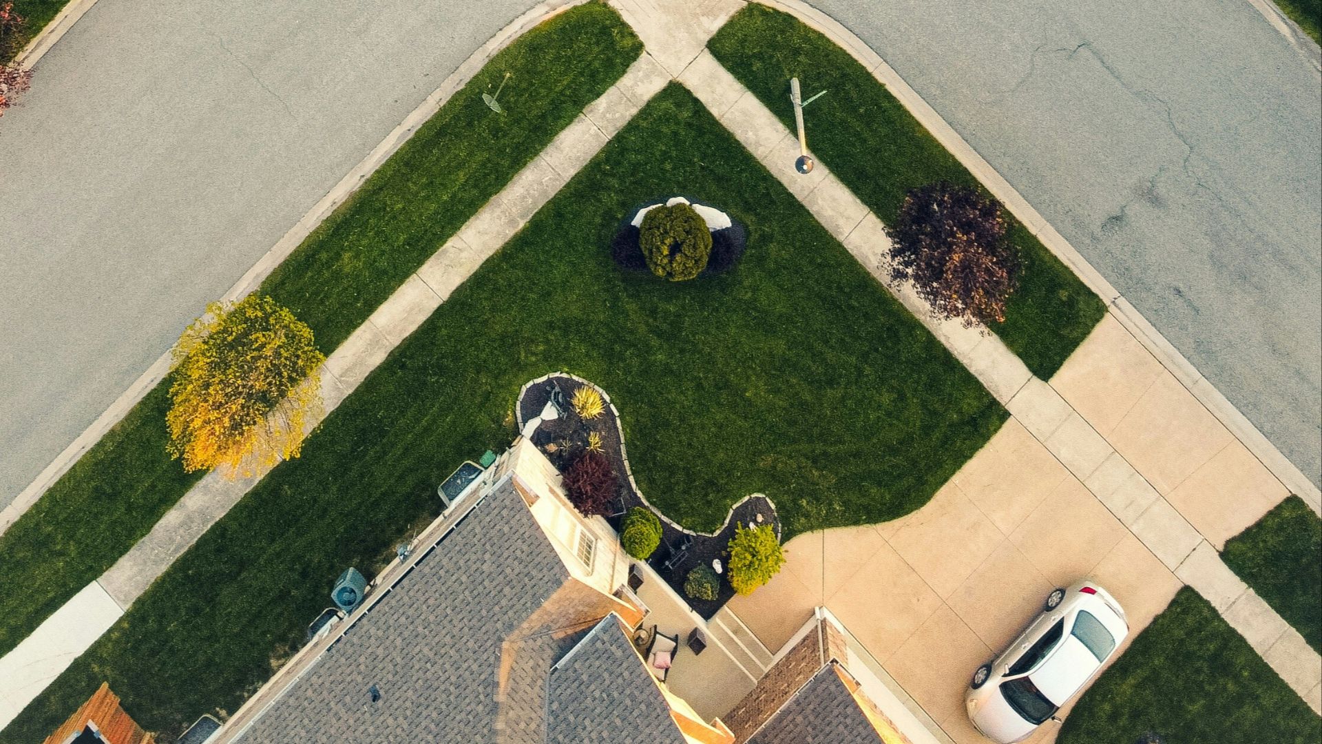 an aerial view of a street intersection in a neighborhood