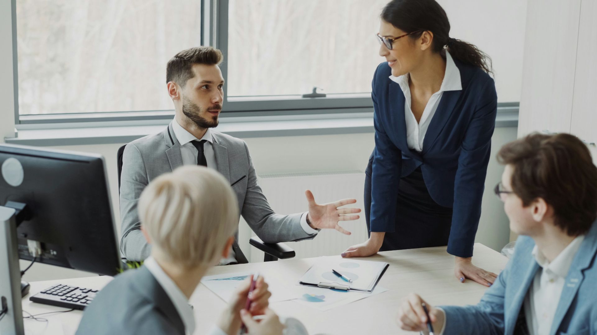 Business professionals collaborating in a modern office meeting.