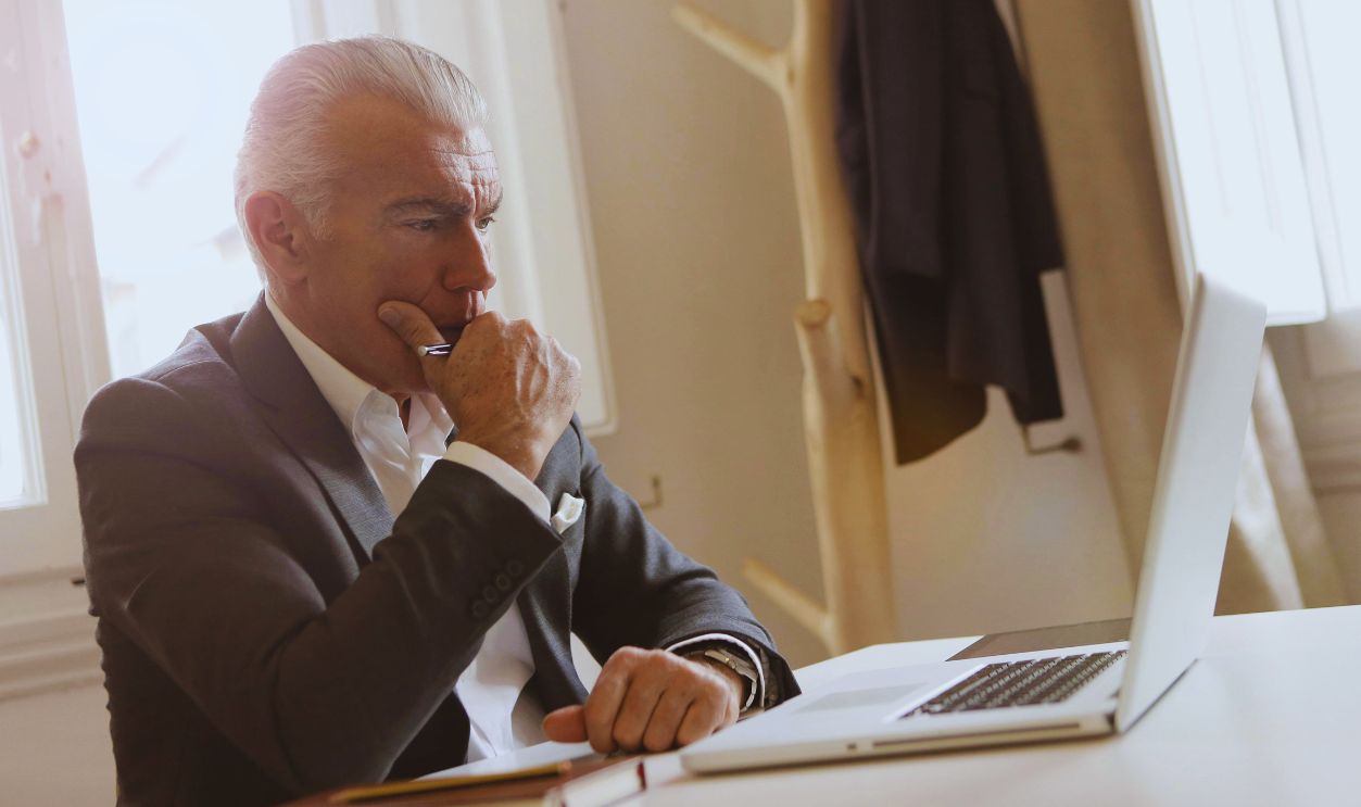 Elder man checking laptop