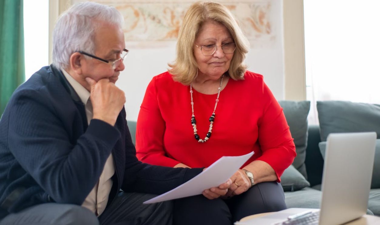 A Man and Woman Looking the Laptop