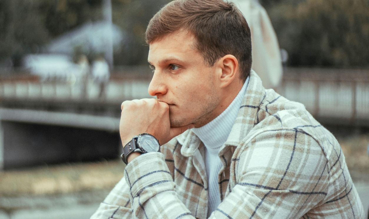Man Sitting by Table and Thinking