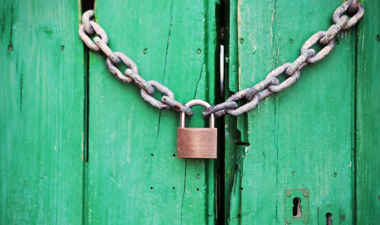 Brass-colored Metal Padlock With Chain