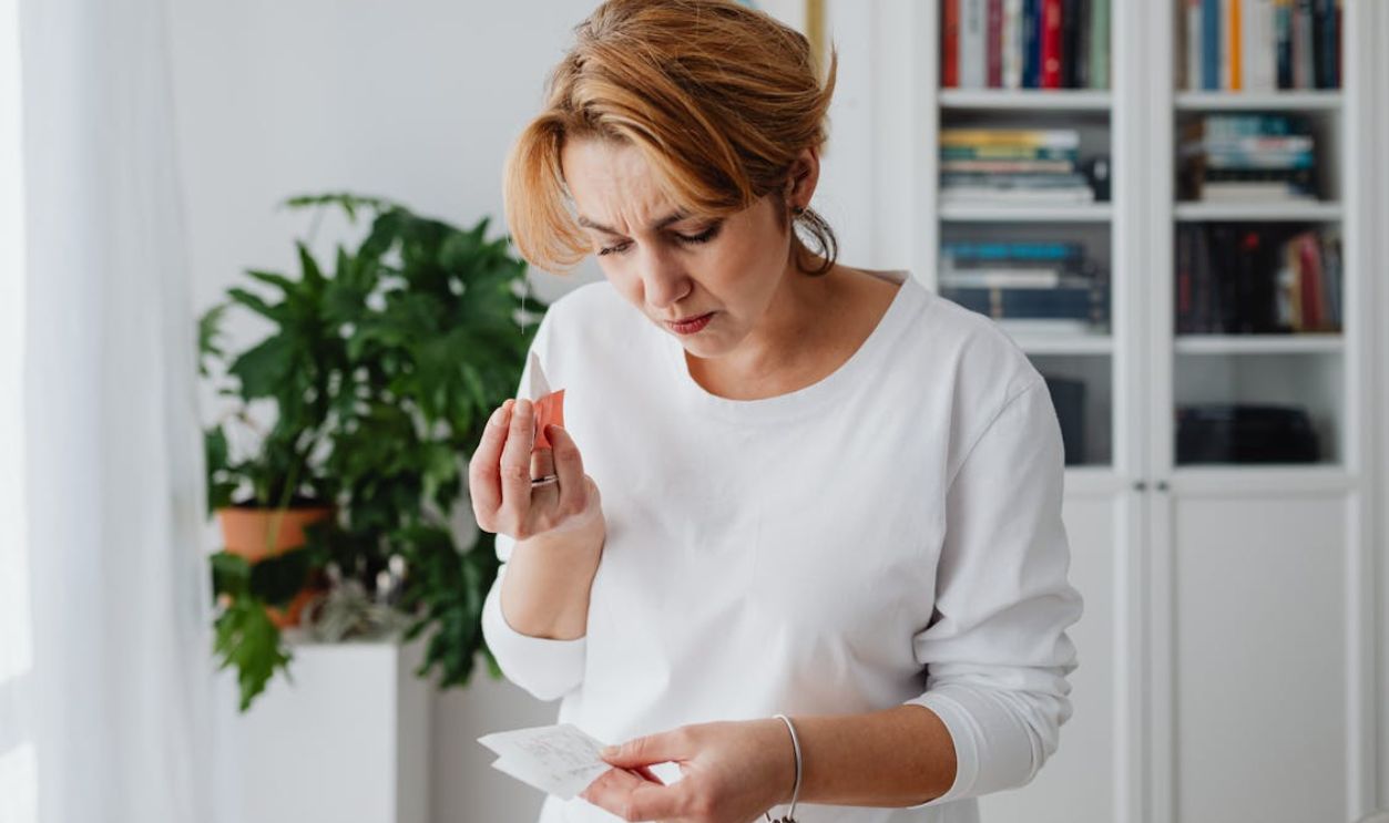 Woman Holding a Receipt