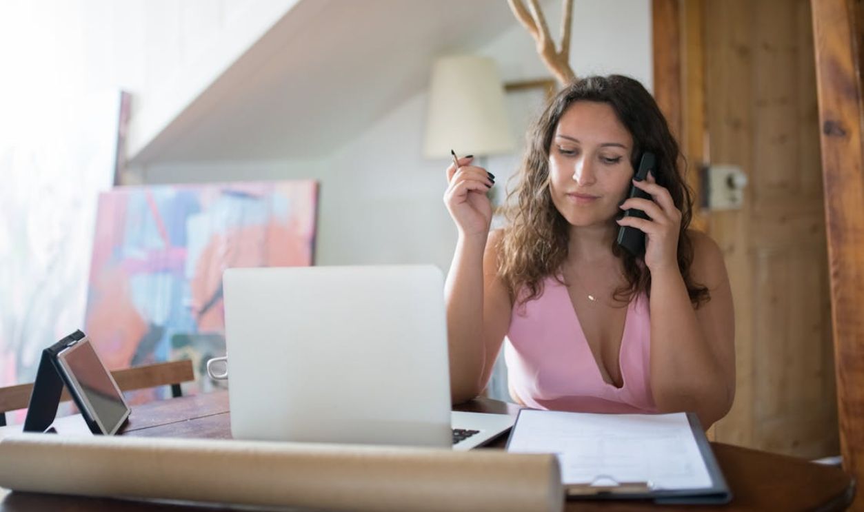 Woman in pink Dress Talking on the Phone