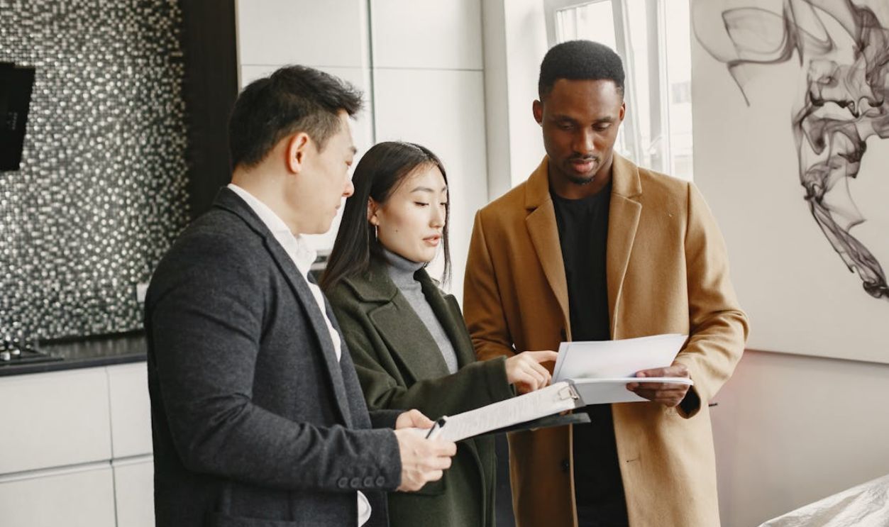 People Having Conversation while Holding Documents