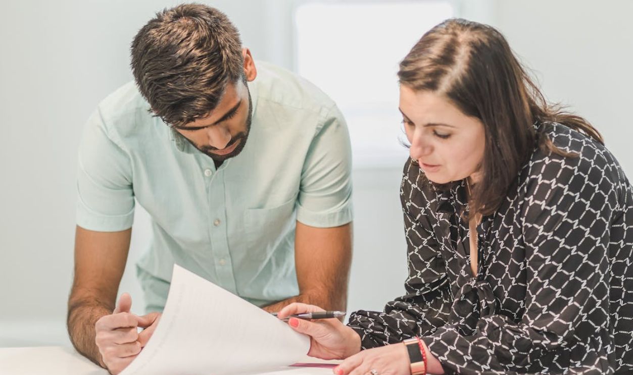 Man and Woman Looking at the Documents