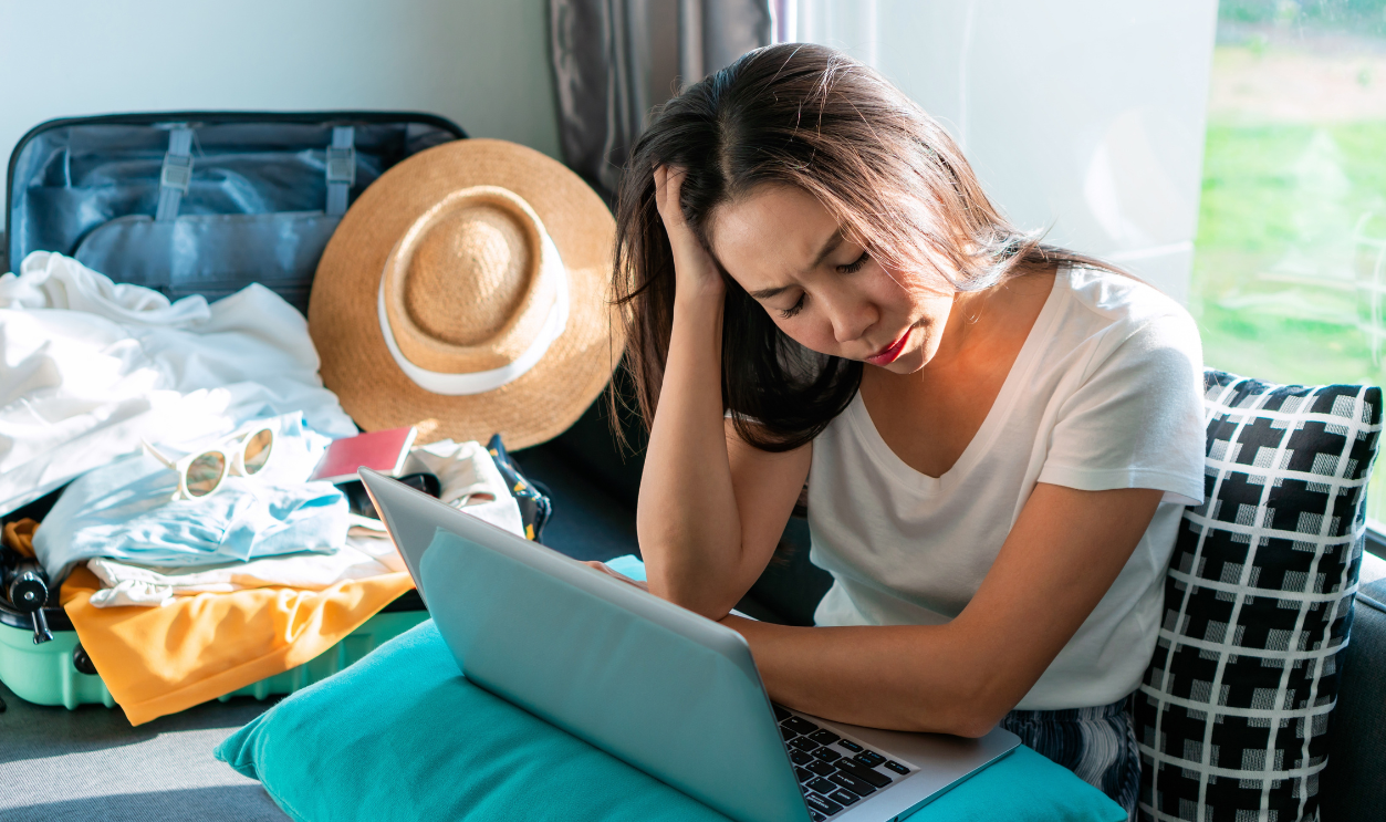 Asian woman is stressed while planning a trip.