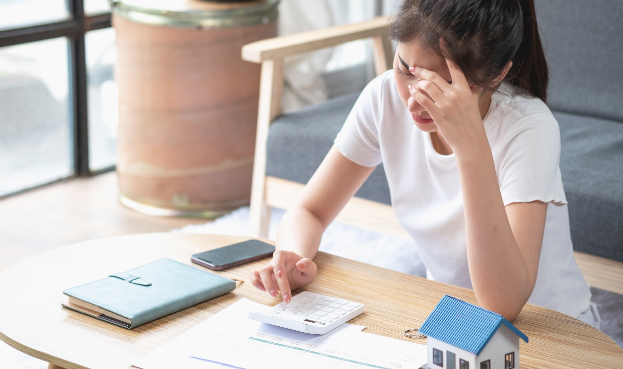 Young Asian woman sitting and calculating expenses
