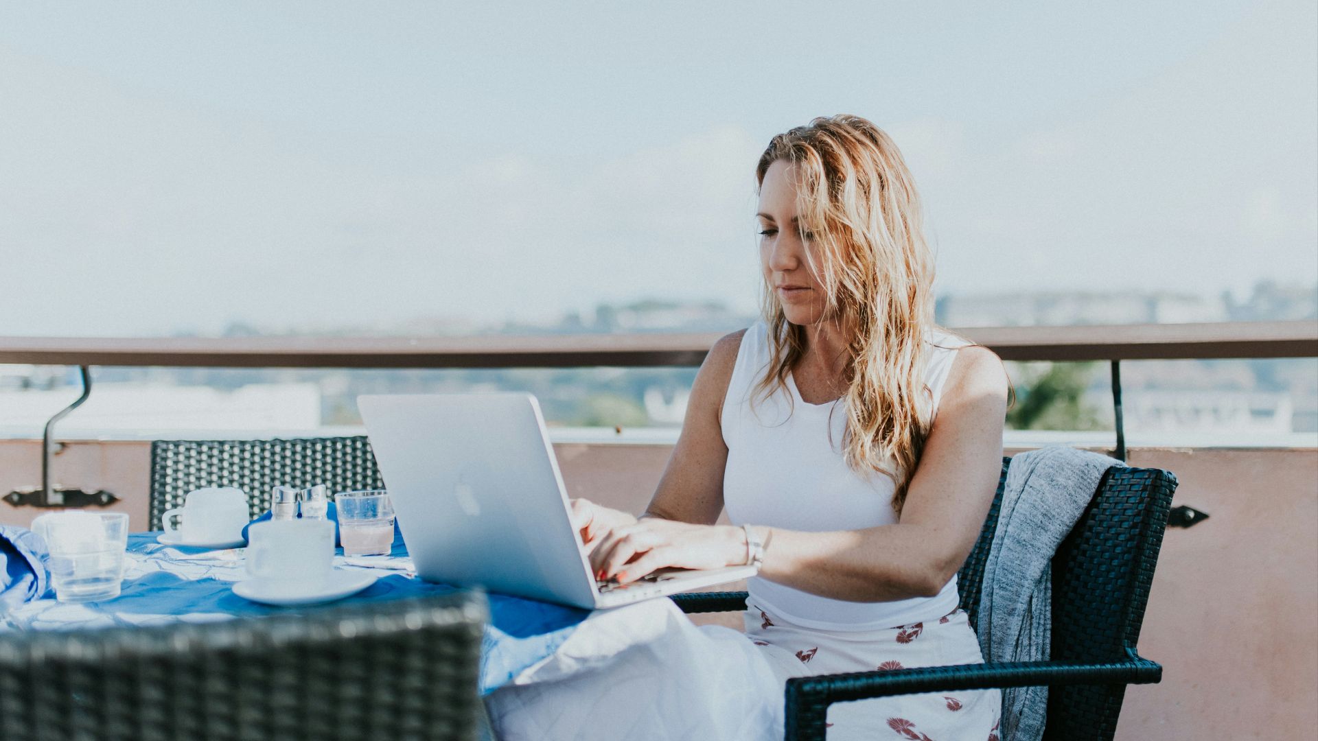 woman sitting on chair while using MacBook