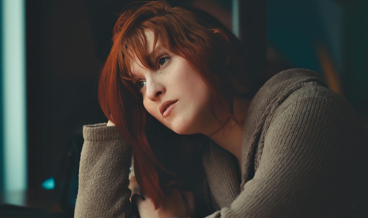 Redhead Girl Sitting Bored at Table