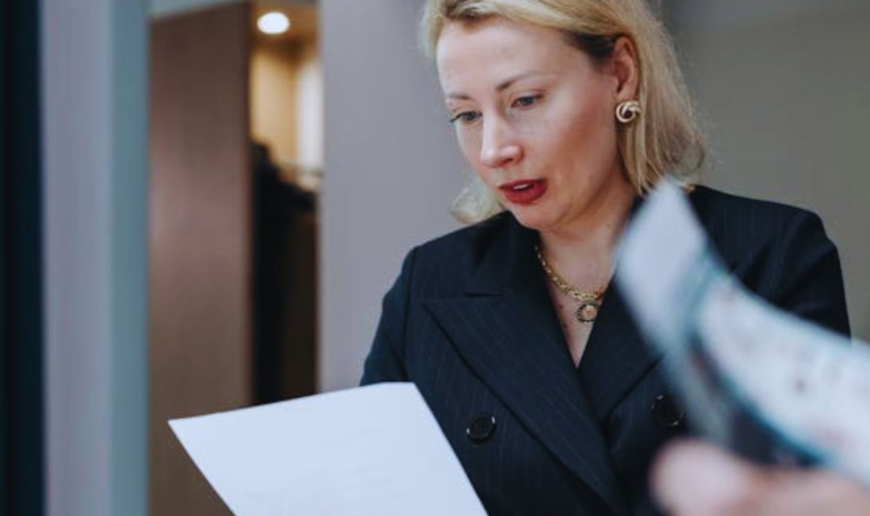 Selective Focus Photo of a Business Woman Reading a Paper