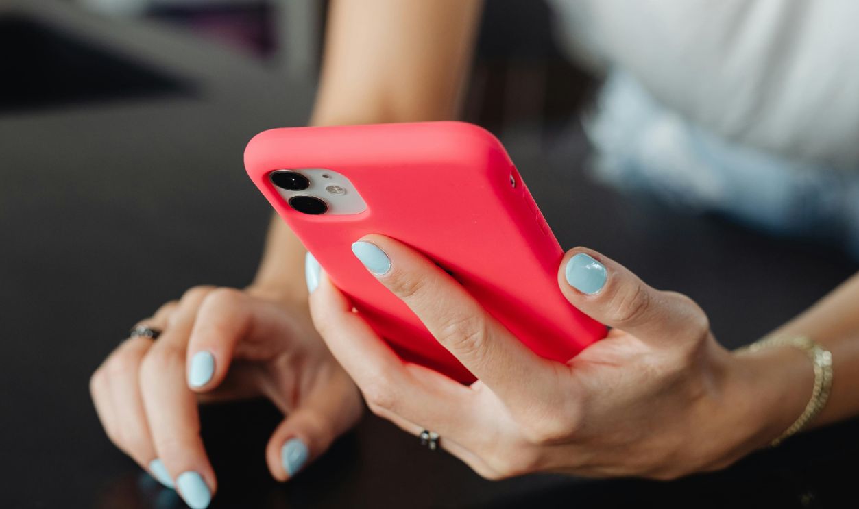 Person Holding a Phone in Red Case
