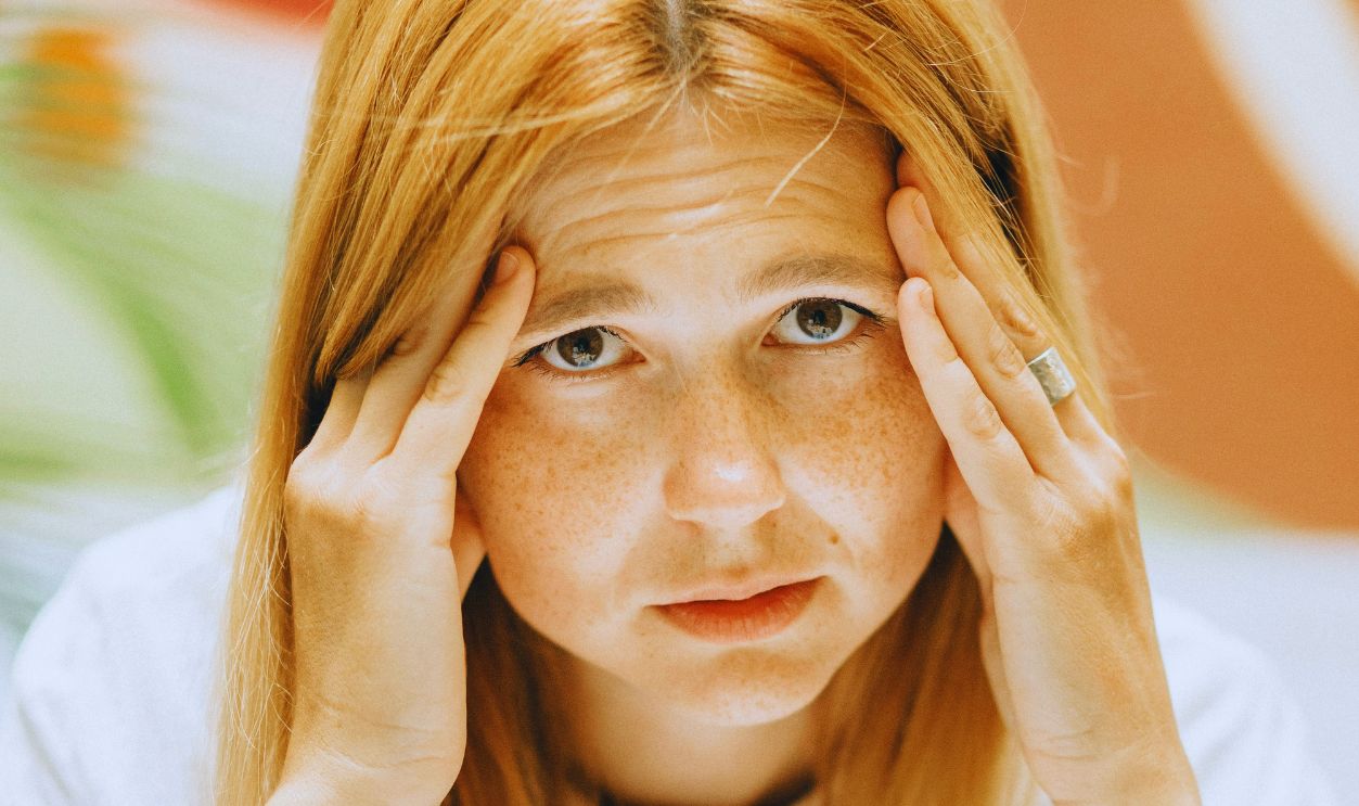 Stressed Woman with Her Hands on Her Face