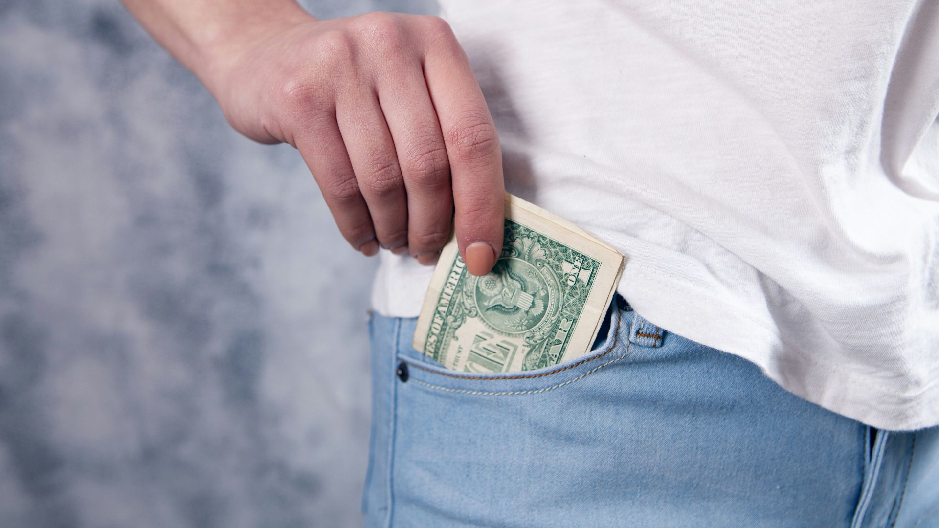 person holding 1 us dollar bill