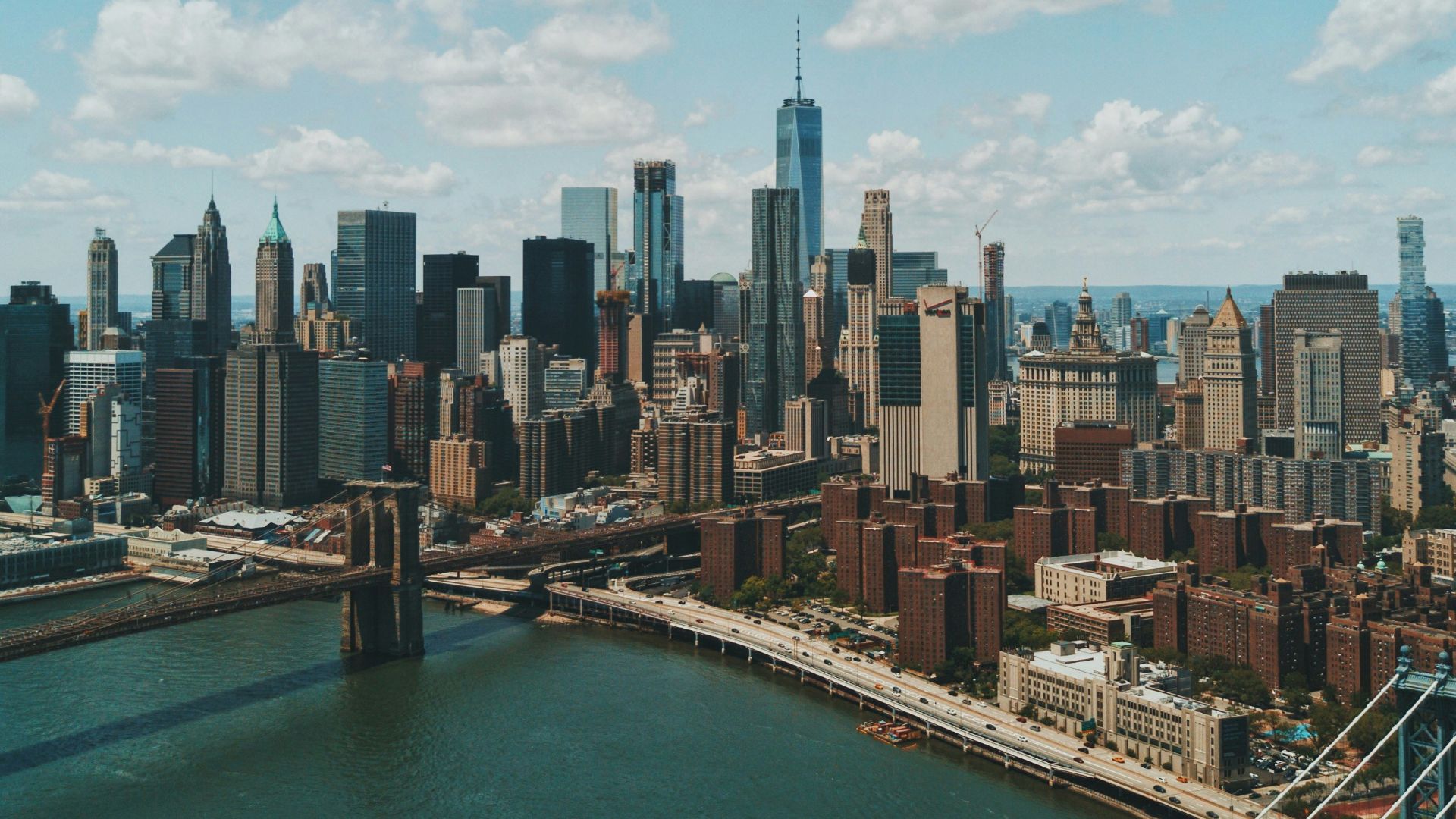 wide angle photo of Brooklyn Bridge under cloudy sky