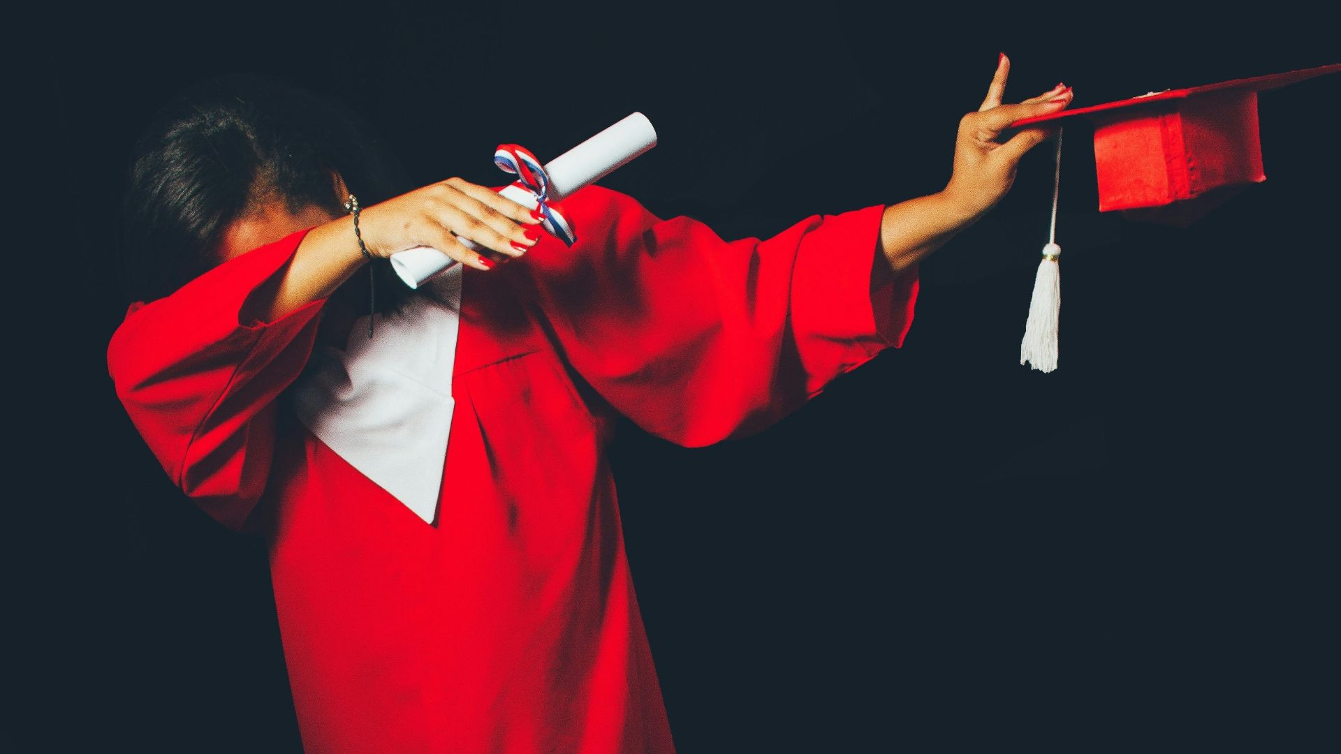 person wearing red graduation dress