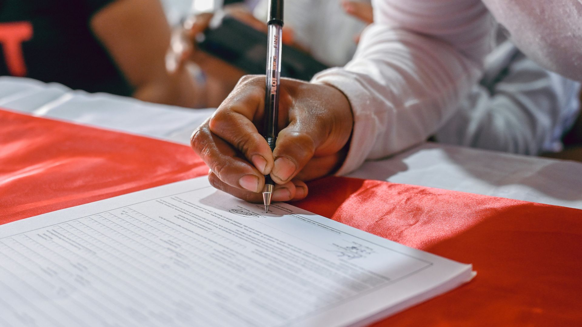 a person writing on a piece of paper
