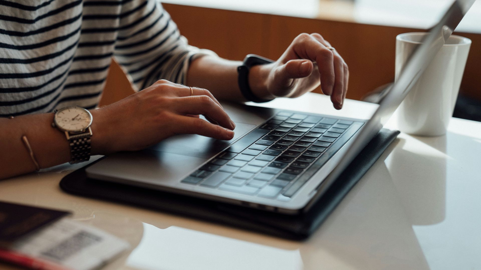 person seated at the table using laptop