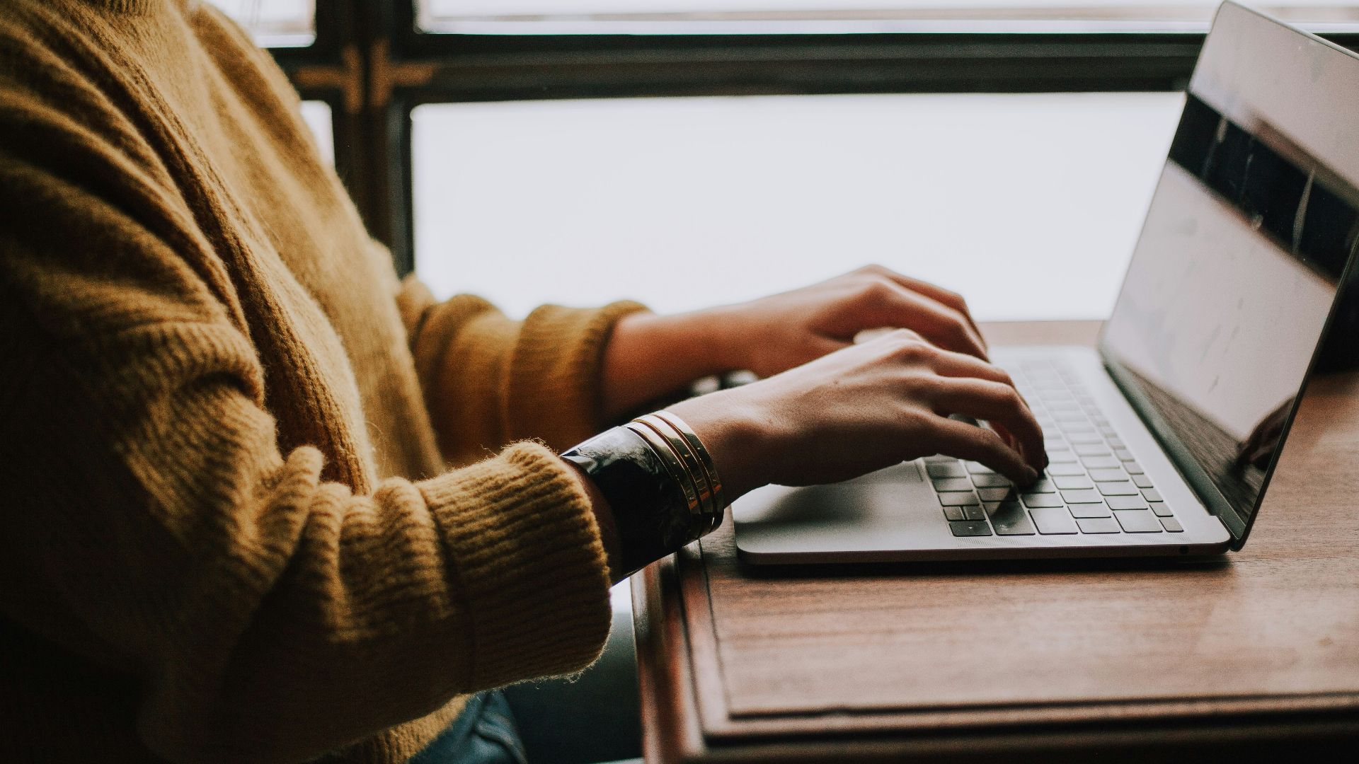 person sitting front of laptop