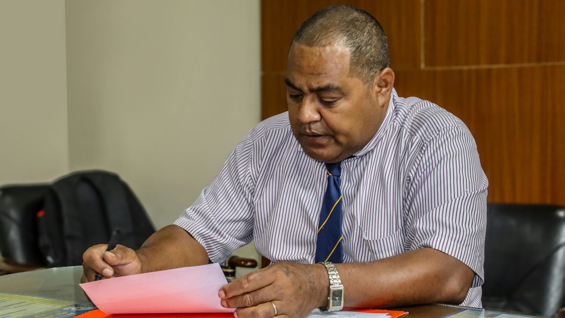 a man sitting at a table with papers in front of him