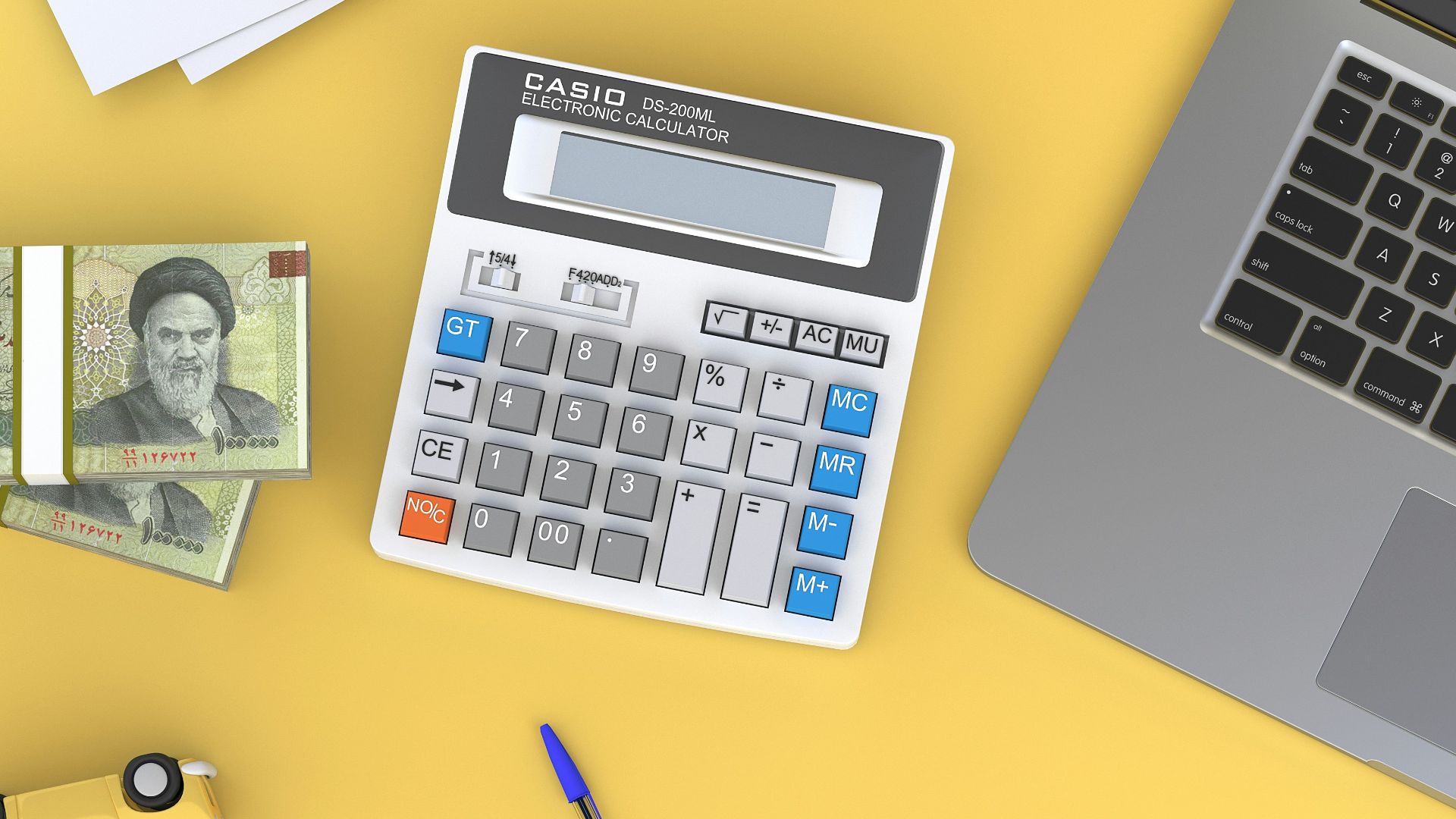 a calculator sitting on top of a desk next to a laptop