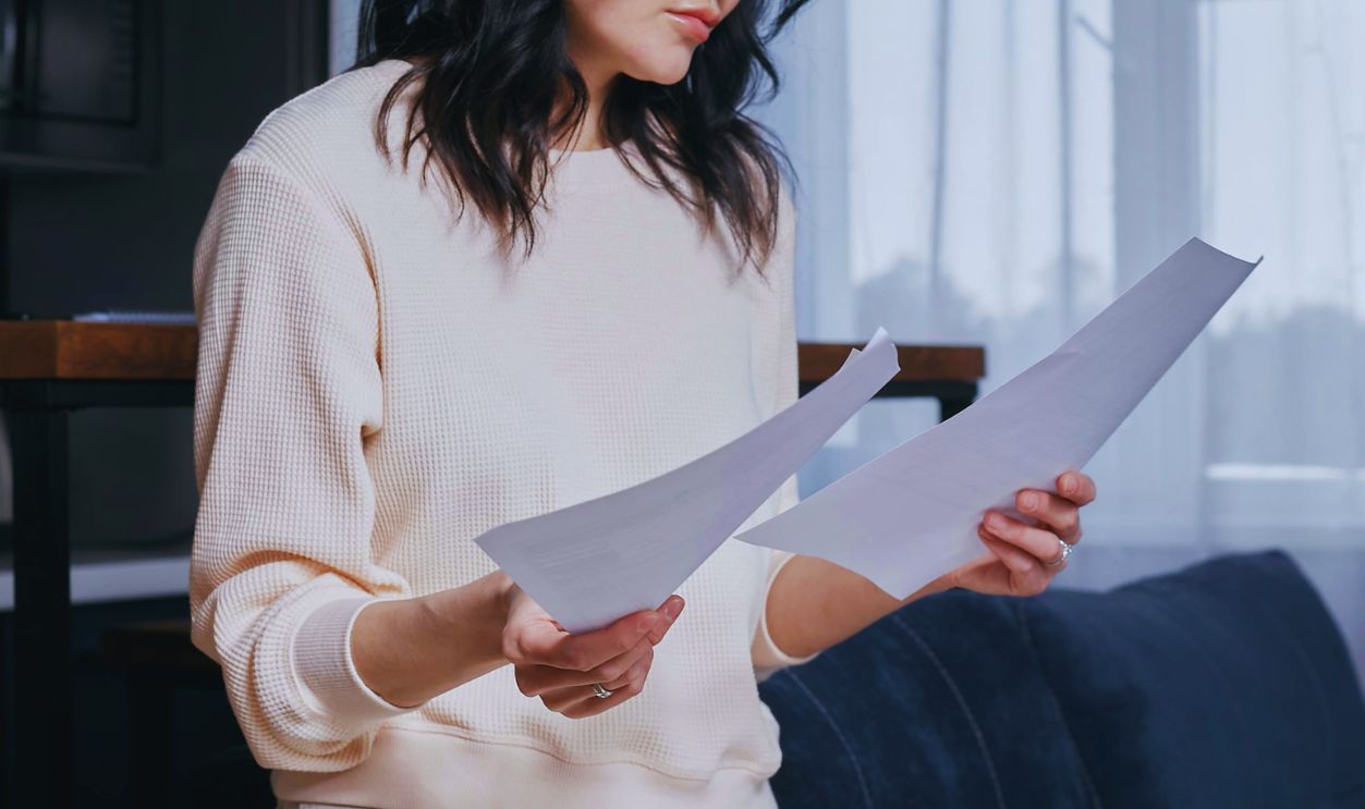 A Woman at Home Reading Documents