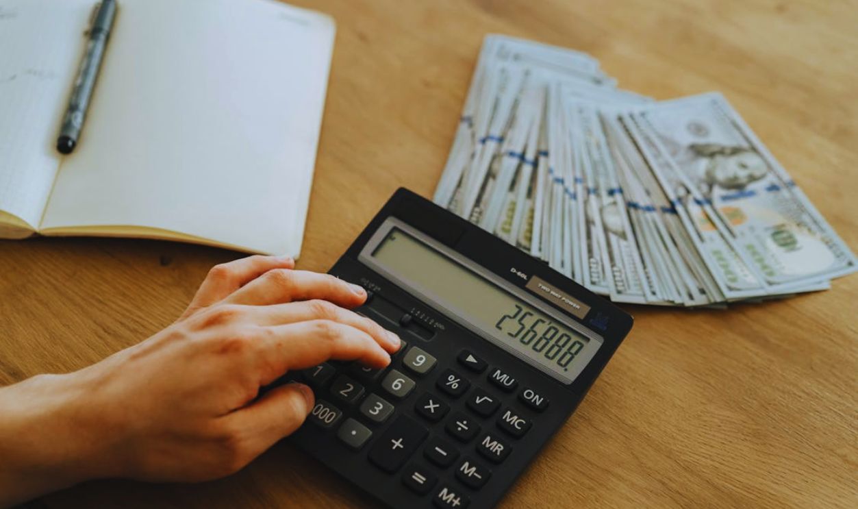 A Person Holding Black Desk Calculator