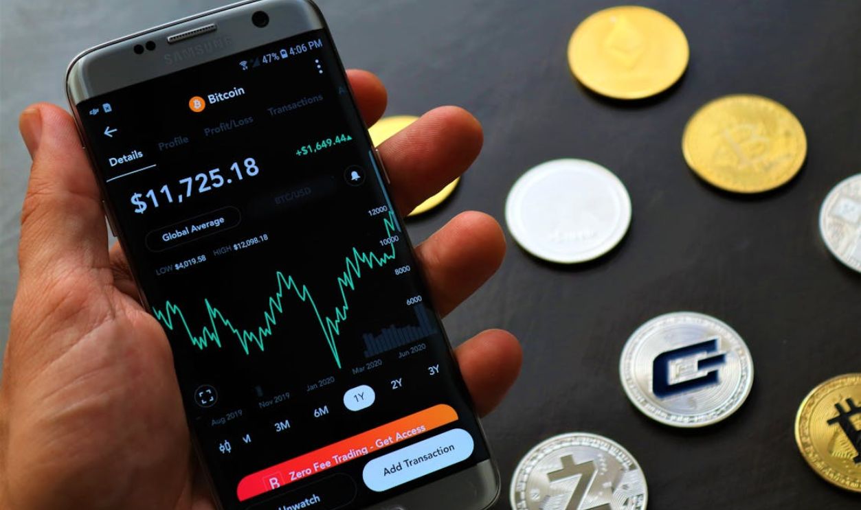 A Hand Holding a Cellphone with Cryptograph