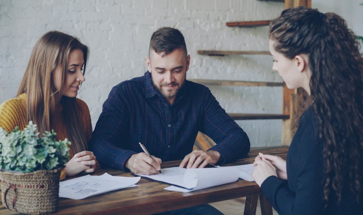 Young Couple Meeting with Real Estate Agent