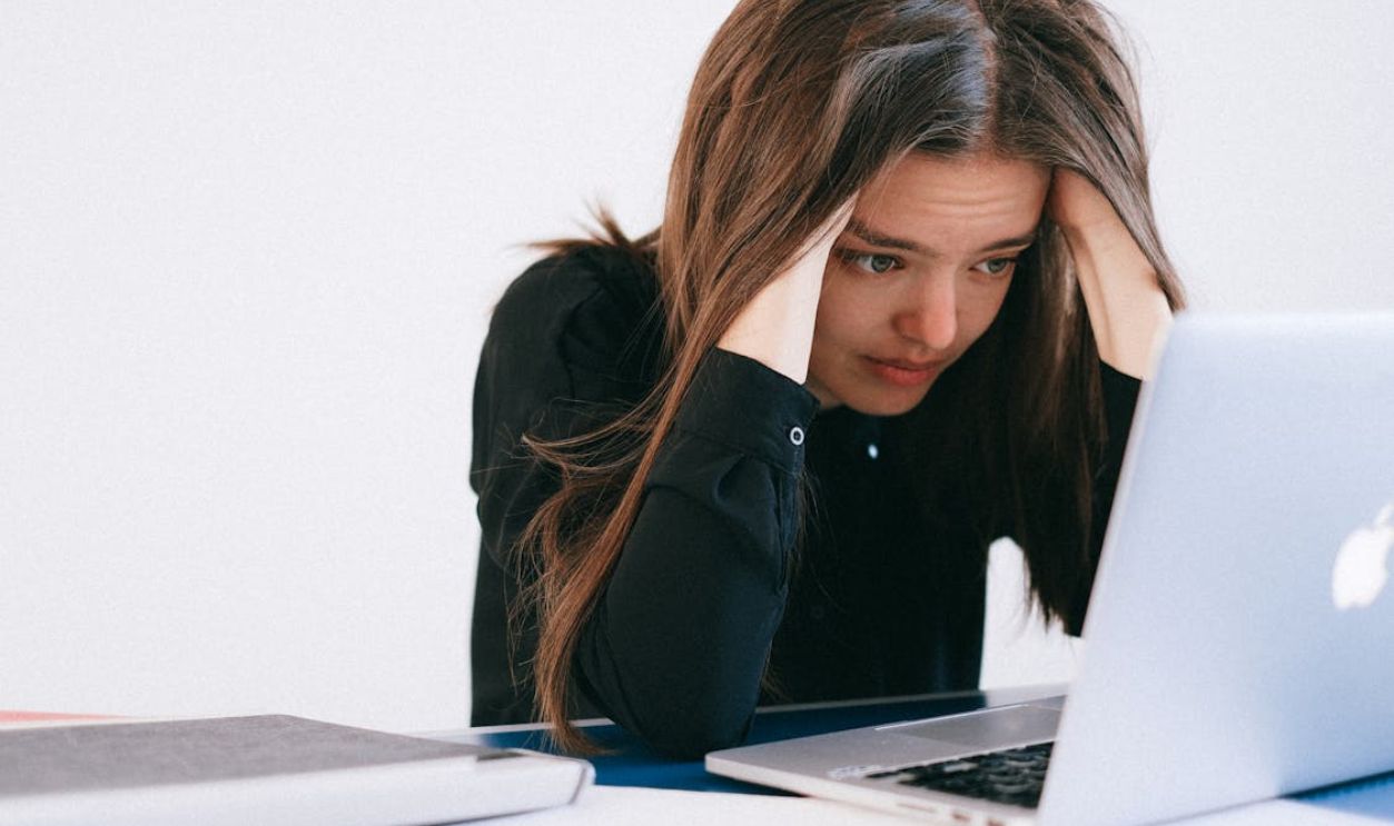 Stressed Woman Looking at a Laptop