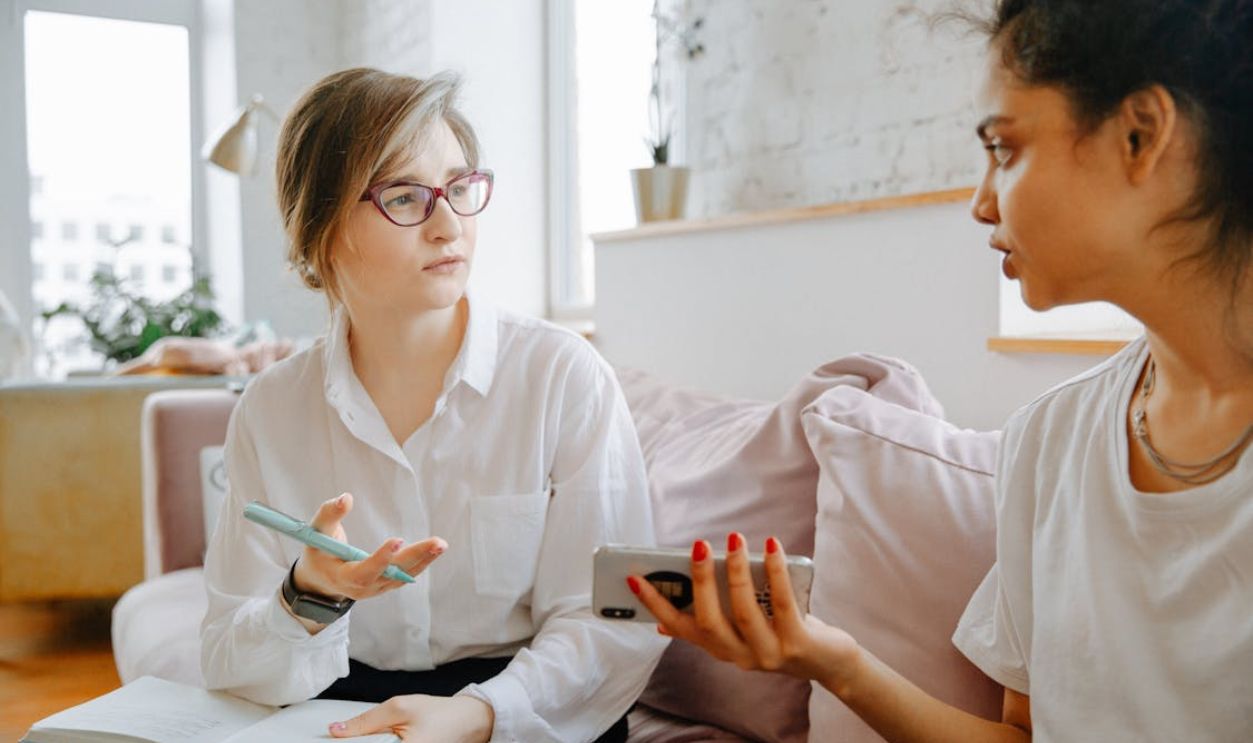 Two People Discussing Dispute Over Documents