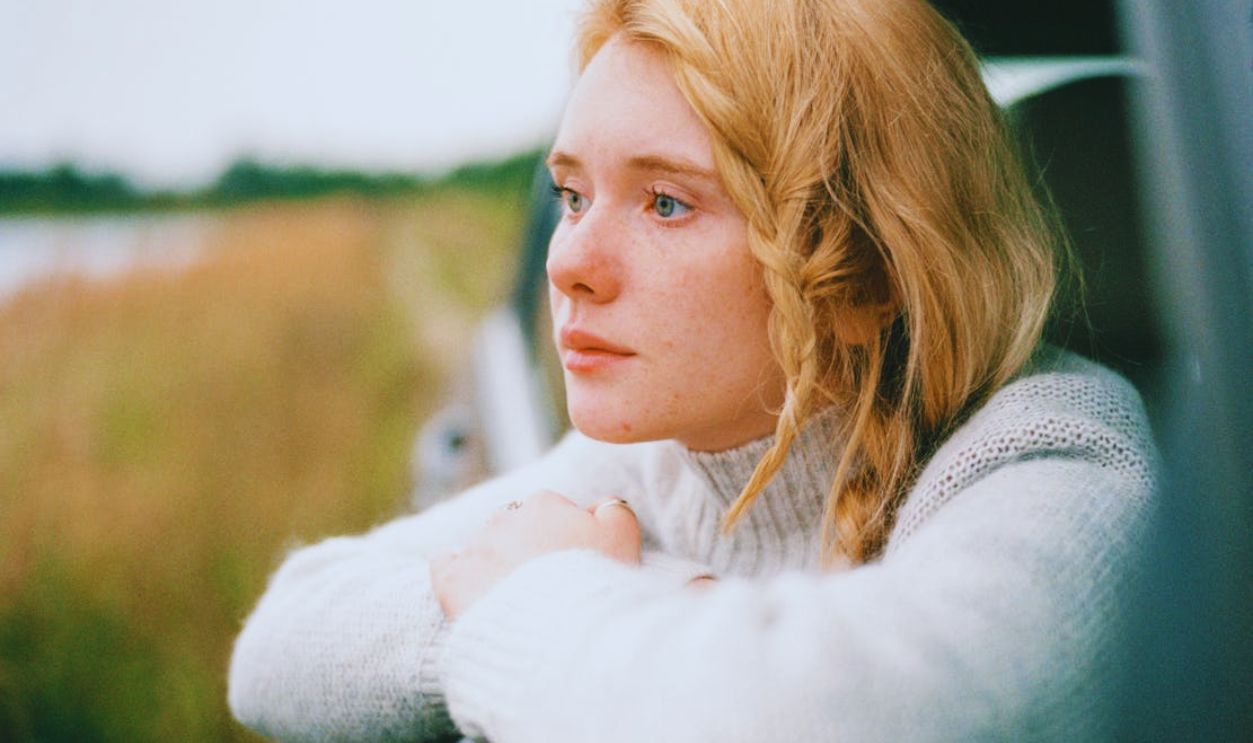 Woman in White Sweater thinking