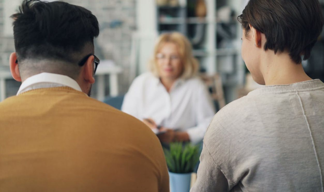 A woman and man sitting at a table talking